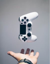 picutre of a hand tossing up a game controller