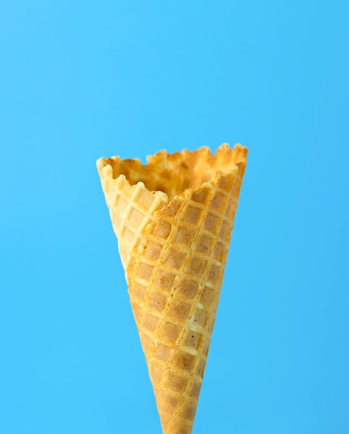 Picture of an icecream cone with a blue background